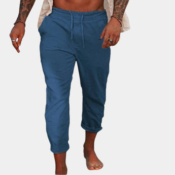 Men's blue linen pants in size 3XL, featuring a lightweight and breathable fabric with an elastic waist, shown on a model standing.