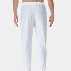 Men's white linen pants showcasing a lightweight and breathable fabric design, with an elastic waist for comfort and flexibility.