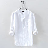 Men's white linen shirt on a clothes hanger, featuring a classic collar and long sleeves, designed for casual wear with a lightweight and breathable fabric.