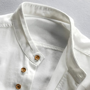 Men's white linen shirt with a classic collar and wooden buttons, featuring long sleeves and a breathable eco-friendly fabric.