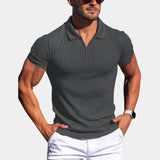 Men wearing a dark gray slim fit stretch cotton polo shirt with short sleeves, standing in a confident pose.