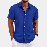 Men's short sleeve dress shirt in blue with white stripes, featuring a comfortable cotton fabric suited for summer wear; model wearing the shirt in size XXL, with an arm showing a wristwatch.