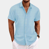 Men's light blue XXL short sleeve cotton dress shirt with white stripes, featuring a classic collar and a comfortable fit, ideal for summer wear. The shirt is displayed on a model wearing a watch on their arm.