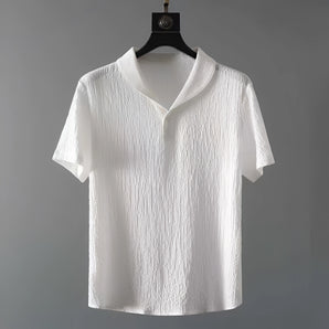 Men's white textured short sleeve polo shirt with a collar, hanging on a clothes hanger. The shirt is designed to be breathable and wrinkle-resistant, showcasing a stylish and modern fashion design.