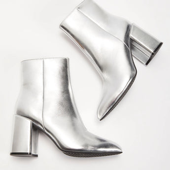 Metallic silver high heel ankle boots showcasing a sleek and trendy design, perfect for making a fashion statement; styled with comfort in mind and available in size 45.