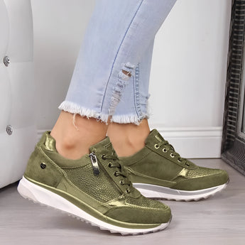 Metallic silver platform sneakers with green accents, size 43, styled on a woman's foot. The trendy footwear features a modern design, ideal for fashion-forward walking shoes.