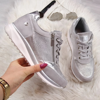 Metallic silver platform sneakers for women, featuring a trendy and fashionable design in a silver color.