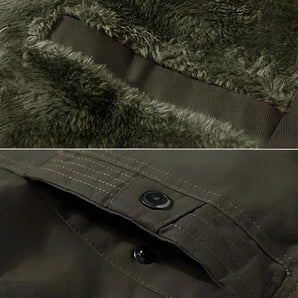 Military green insulated winter jacket with plush lining and button cuffs, featuring a visible sleeve and collar, set against a natural background with trees and grass.
