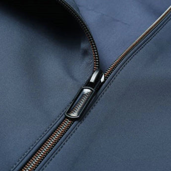 Minimalist dark blue men's bomber jacket laid flat on a surface, showcasing its lightweight and urban fashion design without any visible accessories or additional parts.