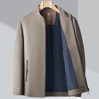 Men's minimalist dark blue bomber jacket with a lightweight design, featuring a sleek collar and long sleeves, styled in an urban fashion setting.