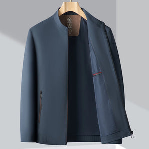 Minimalist dark blue men's bomber jacket with a lightweight design, featuring a sleek collar and long sleeves, perfect for urban fashion.