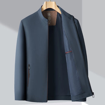 Minimalist dark blue men's bomber jacket with a lightweight design, featuring a sleek collar and long sleeves, perfect for urban fashion.