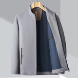 Minimalist dark blue men's bomber jacket, showcasing a lightweight design suitable for urban fashion. The jacket features a sleek collar and long sleeves, blending style elements reminiscent of a coat and blazer.