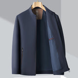 A minimalist dark blue men's bomber jacket featuring a lightweight design ideal for urban fashion, with a sleek silhouette, long sleeves, and a zippered front. The jacket has a classic collar and is styled for a casual yet sophisticated look, distinguishing itself from traditional blazers or formal wear.