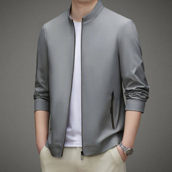 Men's light gray bomber jacket in a minimalist design, featuring a lightweight fabric suitable for urban fashion. The jacket has a collar, long sleeves, and pairs well with a dress shirt or sportswear. It is shown in size 3XL.