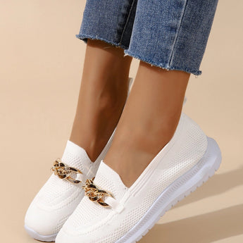 Minimalist white sneaker with a seamless design and lightweight sole being worn with denim jeans, showcasing a casual and stylish look.