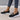 Minimalist white sneaker with a seamless design featuring a lightweight sole, shown in the Nero1 / 422 variant. The shoe is primarily white with subtle black and grey accents, suitable for fashion-forward sportswear and casual denim outfits.