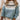 Mint green Fair Isle women's sweater featuring a cozy Scandinavian knit pattern, showcased on a mannequin with arms outstretched, highlighting the intricate design and craftsmanship.