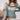 Mint green Fair Isle women's sweater featuring a cozy Scandinavian knit design, modeled by a person showcasing the sweater's long sleeves, shoulder, and neck details.