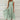Mint green sleeveless chiffon high-low cocktail dress with a lace bodice, designed for a plus size, shown in size 4XL.