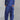 Modern white lace-up blouse paired with high-waist designer pants in electric blue, showcasing a sophisticated workwear style.