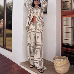Monochrome geometric jumpsuit displayed indoors, showcasing bohemian luxury wear with intricate textile patterns and a stylish one-piece design.
