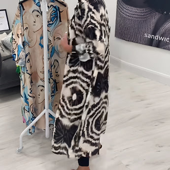 Monochrome tie-dye geometric kaftan dress with flowing sleeves and relaxed fit, styled as luxury beachwear.