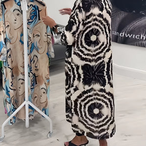 Monochrome tie-dye geometric kaftan dress styled with elegant patterns, suitable for luxury beachwear, featuring loose sleeves and a flowing silhouette.
