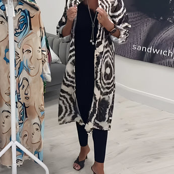 Monochrome tie-dye geometric kaftan dress featuring a loose, flowing design, perfect for luxury beachwear. The dress showcases long sleeves and a stylish pattern that combines elegance and comfort.