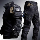Person wearing a black 2XL multi-camouflage tactical uniform with cargo pants, gloves, headgear, and a bag, ideal for workwear and sports gear.