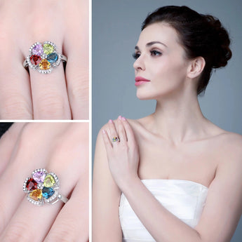 Woman wearing a multi-color gemstone sterling silver 925 floral ring on her finger.