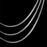 A multi-layer minimalist silver necklace with lightweight and versatile design, featuring delicate metal chains and geometric shapes.
