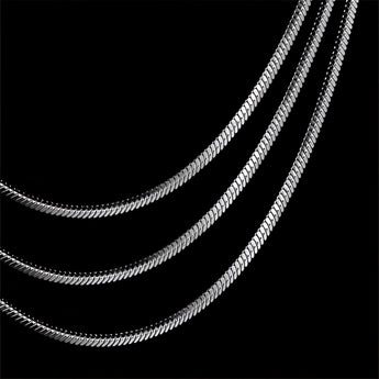 A multi-layer minimalist silver necklace with lightweight and versatile design, featuring delicate metal chains and geometric shapes.