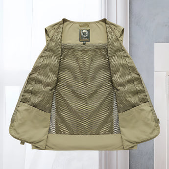 Lightweight, breathable tactical mesh vest in grey, featuring multiple pockets, displayed on a clothes hanger with a dress shirt underneath.