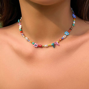 Multicolor beaded choker necklace featuring floral designs, perfect for boho summer beach style.