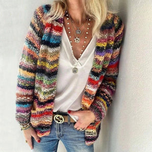 Oversized multicolor Bohemian chunky knit wool cardigan in red, featuring a loose fit with long sleeves and a cozy texture, styled over a casual outfit.