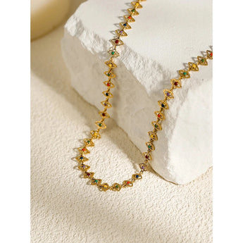 18K gold plated necklace featuring multicolor gemstones, draped elegantly on a neck.