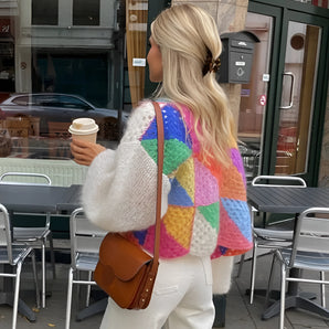Multicolor patchwork cardigan with long sleeves in a cozy boho chic style, displayed on a mannequin or flat lay, showcasing the intricate knit pattern in a variety of colors, suitable for fall fashion.