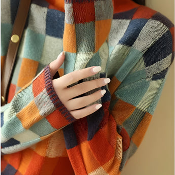 A multicolor plaid women's turtleneck sweater with an autumn knit design, featuring vibrant orange and tartan patterns, long sleeves, and a cozy high collar.