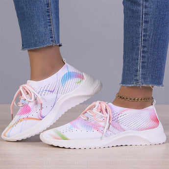 Multicolor women's breathable lightweight athletic sneakers featuring a purple and azure design, shown being worn on a human leg.