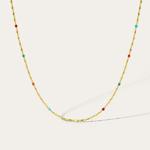 Gold-tone multicolored gemstone necklace with various shapes and symmetrical patterns, featuring YA-CHAN original design in gold and beads.