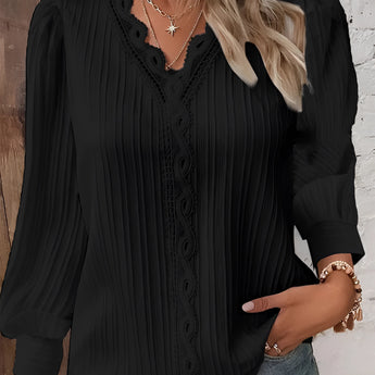 
A woman wearing a mustard lace detail ruffled blouse with long sleeves.