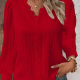 A woman wearing a mustard lace detail ruffled blouse featuring long sleeves, with attention to the intricate lace and ruffle design around the collar and cuffs.