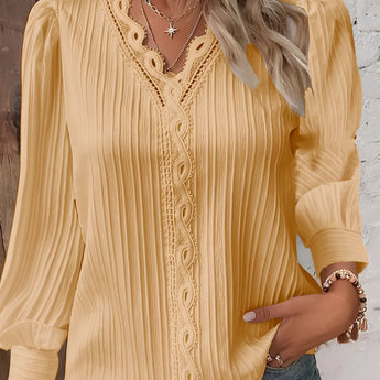 A mustard-colored women's long sleeve blouse featuring lace details and ruffles, with a focus on the neckline and shoulder area.
