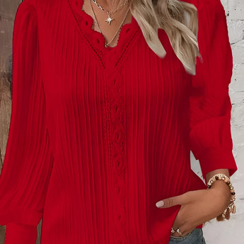 A woman wearing a red 4XL long sleeve blouse with lace details and ruffled accents around the collar and sleeves.