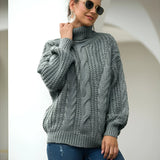 A gray cable knit turtleneck sweater with a chunky design, featuring long sleeves and a cozy fit, perfect for autumn fashion.