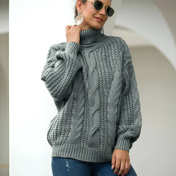 A gray cable knit turtleneck sweater with a chunky design, featuring long sleeves and a cozy fit, perfect for autumn fashion.
