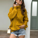 A person wearing a mustard yellow cable knit turtleneck sweater in an XL size, perfect for chunky autumn fashion. The sweater features long sleeves and a cozy turtleneck design. The individual is also wearing sunglasses and is styled in a casual, stylish manner.