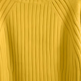 A mustard yellow pleated turtleneck sweater made of cozy knit fabric, displayed on a wooden surface, showcasing its textured pattern and warm shade ideal for winter wear.