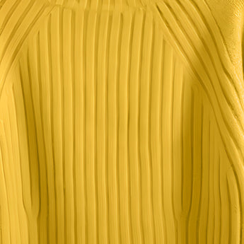 A mustard yellow pleated turtleneck sweater made of cozy knit fabric, displayed on a wooden surface, showcasing its textured pattern and warm shade ideal for winter wear.